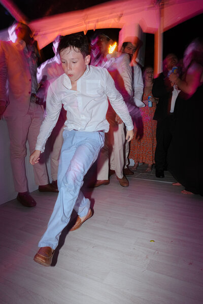bride and groom twirling on blue checker dance floor at Mission Hills Country Club Kansas City wedding