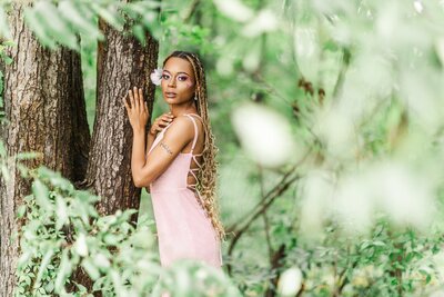 woman in pink dress posing with tree and greenery in albany ny
