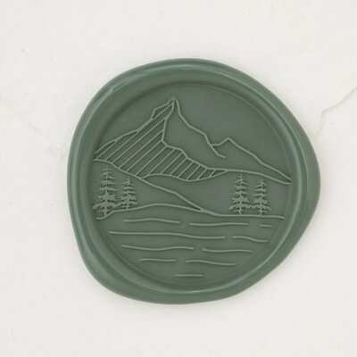 Mountain destination wedding wax seal with mountain scenery and trees