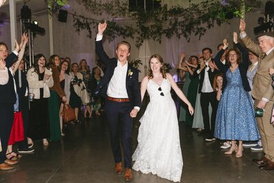 Excited bride and groom leaving their wedding reception at the Woodlands Colorado