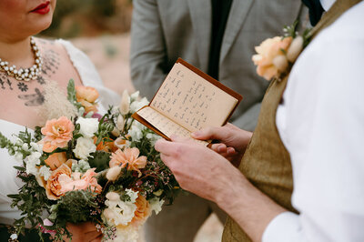 groom reading his vows to his bride