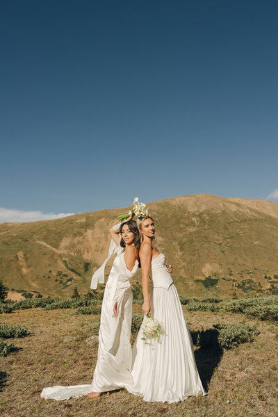 documentary style brides lean back to back in the desert