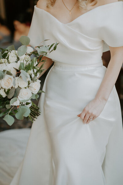 white satin wedding gown and bouquet