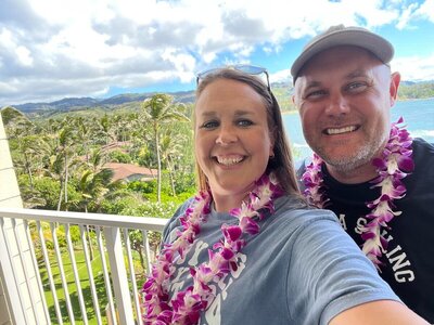 Photo of couple at a tropical resort with tropical attire on with all inclusive destination wedding packages with CC Vacations