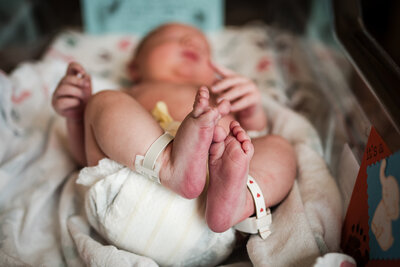 Baby's feet with an adult hand