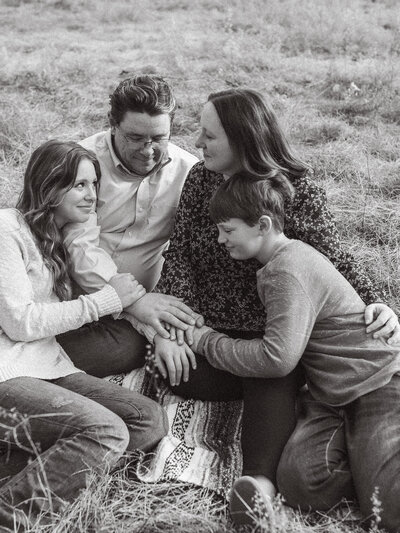 A family of four sitting on a blanket at The Vine Photography Venue in Ackworth, GA.