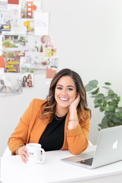 orlando realtor latina sitting at an office desk with laptop