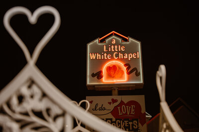 A photo of the little white chapel  neon sign in Las Vegas at night.