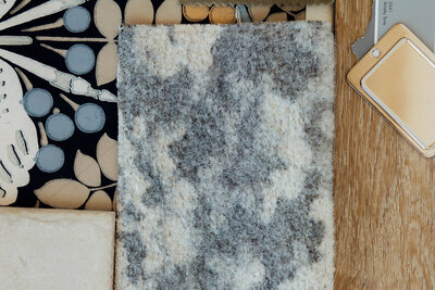 A close up of fabric and paint swatches representing custom home interior design by Winsome Home Interiors.