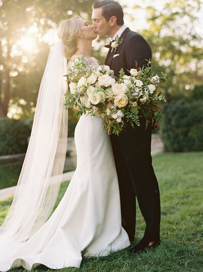Classic white and green wedding and bridal bouquet. Black-tie southern style wedding with roses and greenery. Design by Rosemary and Finch in Nashville, TN.