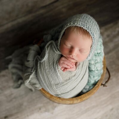 Newborn baby boy in a green hat