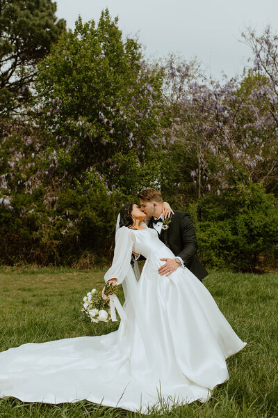 husband dips wife in field