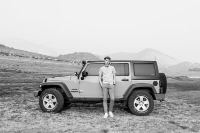 Senior guy standing with his Jeep