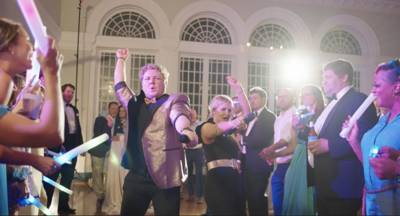 performers dancing in a soul train line at a wedding