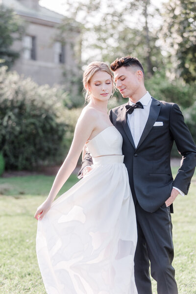 groom holding bride as she twirls her dress