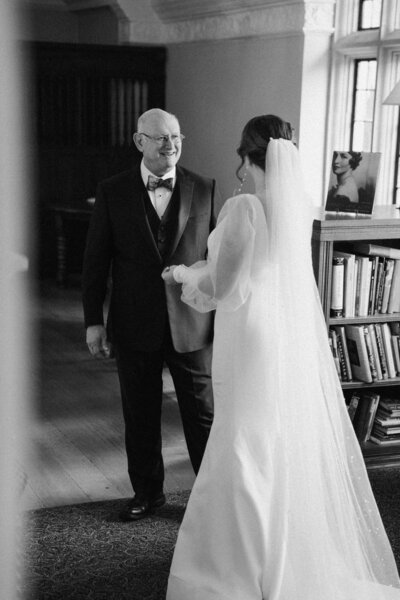 Bride and groom sharing a joyful moment in their suite at a Williamsburg, Brooklyn hotel during their New York City wedding.