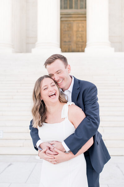 couple laughing  white dress and blue suit