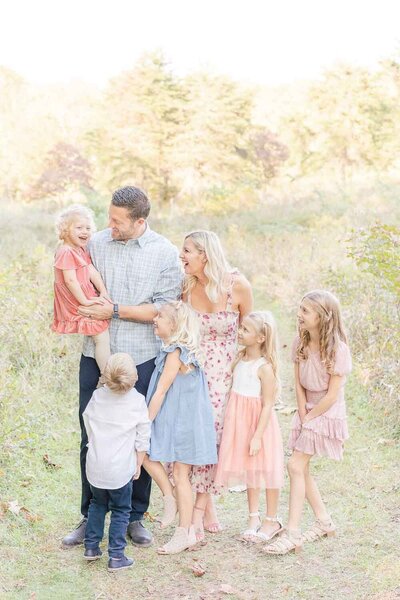 family laughing so hard on a sunny day during Prince William County, Virginia fall mini session