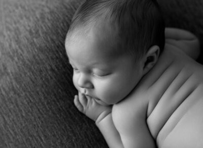 newborn baby boy sleeping on his belly