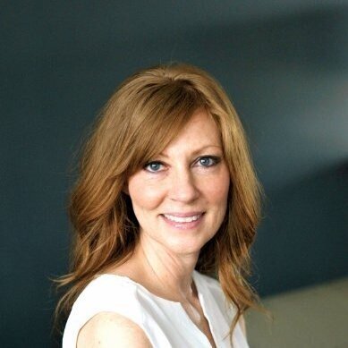 Karen hansen smiling at camera with dark blue background