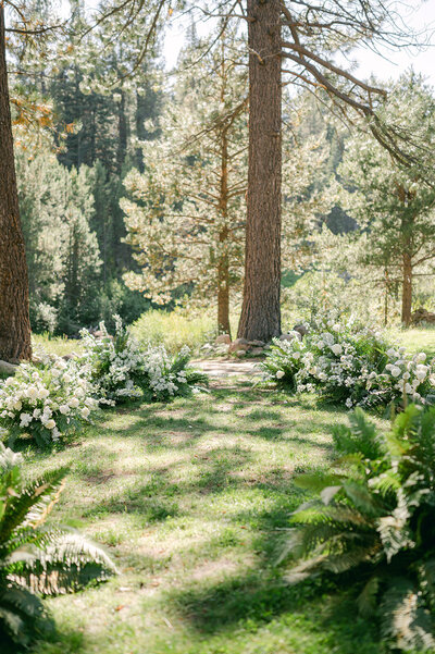 Wedding Ceremony with Floral Ground Installation at Dancing Pines Wedding Venue in Lake Tahoe, CA.