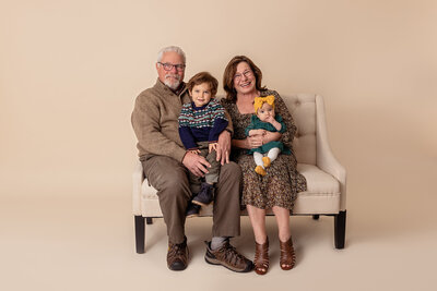 grandparents posing with grandkids in studio by Philadelphia Newborn Photographer
