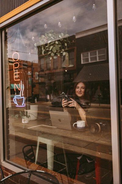 Three Bridge Photography posing in a coffee shop during branding session