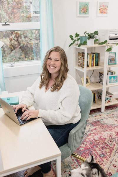 SEO strategist Julia Bocchese sitting at office desk with husky