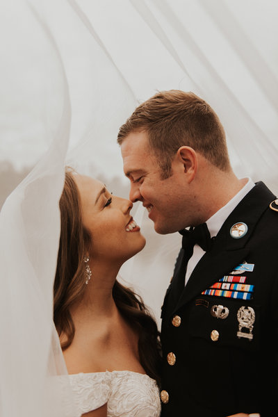 bride and groom military touching noses