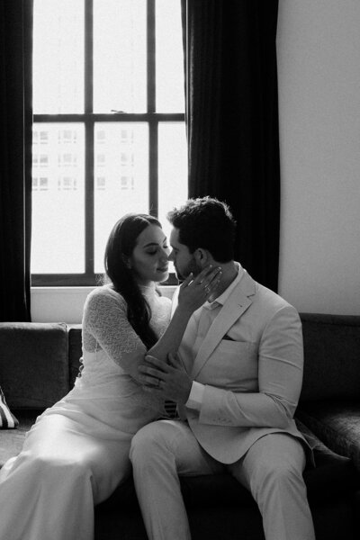 newlyweds in hotel suite cuddling