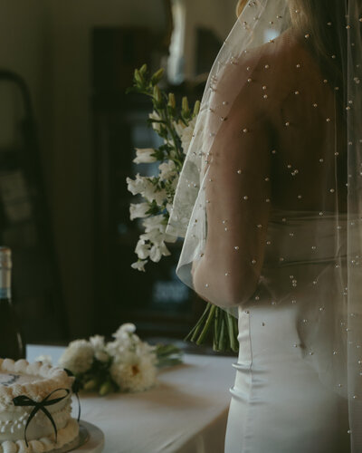 Moody detail of bride's veil and dried floral bouquet during their Coronado House micro-wedding in Phoenix