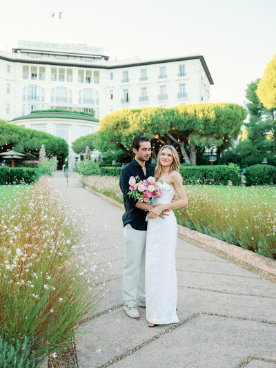 Lindy and Adam, Provence Wedding Couple in front of the arch of flowers
