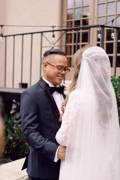 Groom holding the bride’s waist in a candid, intimate moment during their Richmond, VA wedding.
