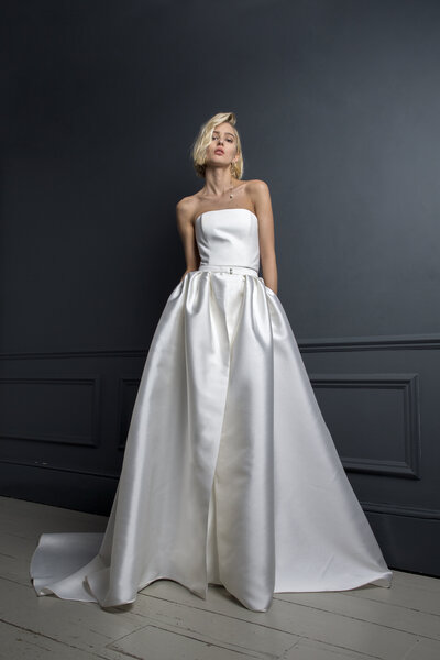 black and white image bride wearing strapless satin wedding dress with long train