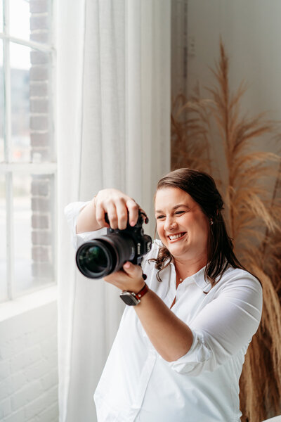 Women taking a photo and smiling.