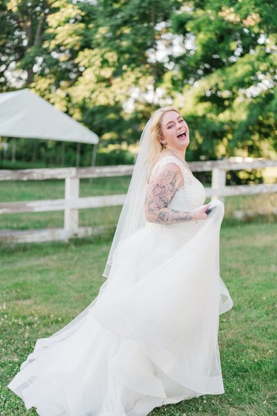 A bride holds her dress and laughs as she runs. 