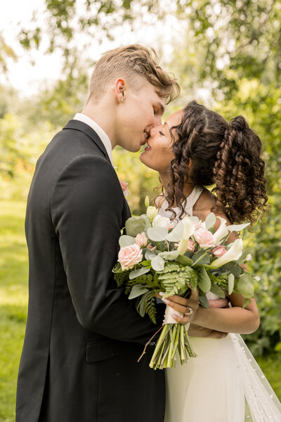 Bride and groom kissing on their wedding day
