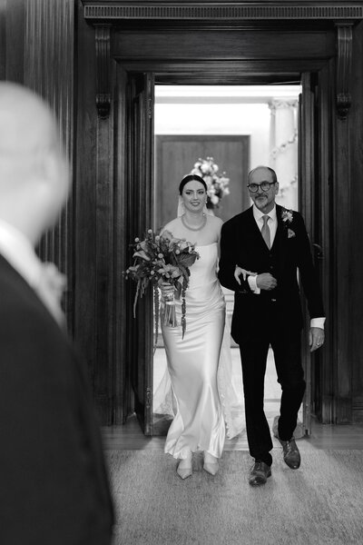 Wedding photographer captures couple taking a stroll hand in hand at their french chateau wedding.