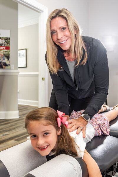 Dr. Tori Ritchie, DC adjusting a child