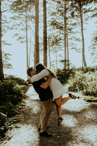 Couple kissing each other under the trees