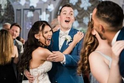 Bride and groom dancing and laughing during fun wedding reception in Northern New Jersey