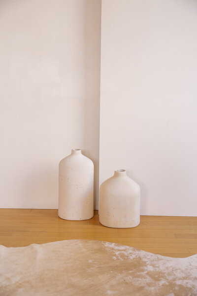 Two empty stone vases side by side.