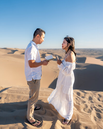 Glamis Sand Dunes California elopement ceremony with bride and groom exchanging vows during sunset
