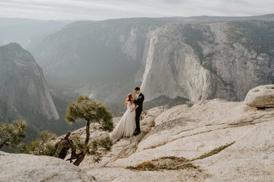 bride and groom kissing on beach