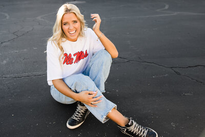 high school senior girl posing for senior photo on the street