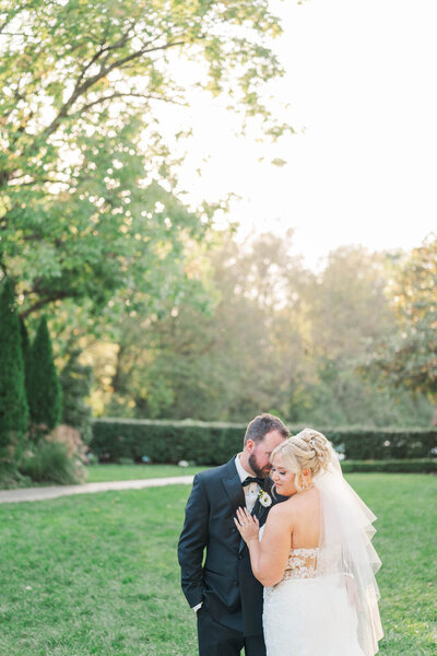 Bride and groom embrace during their wedding portraits at The Signature Club of Lansdowne