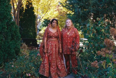 Bride and groom standing in front of beach house