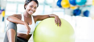 Woman smiling with exercise ball