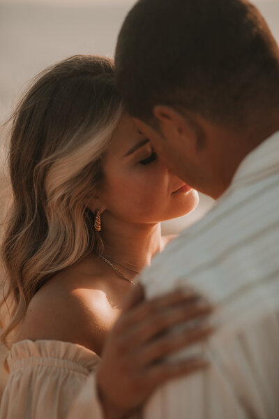 couple on beach engagement session at sunset