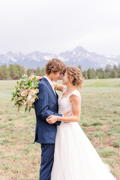 beautiful bride and groom image in front of mountain backdrop